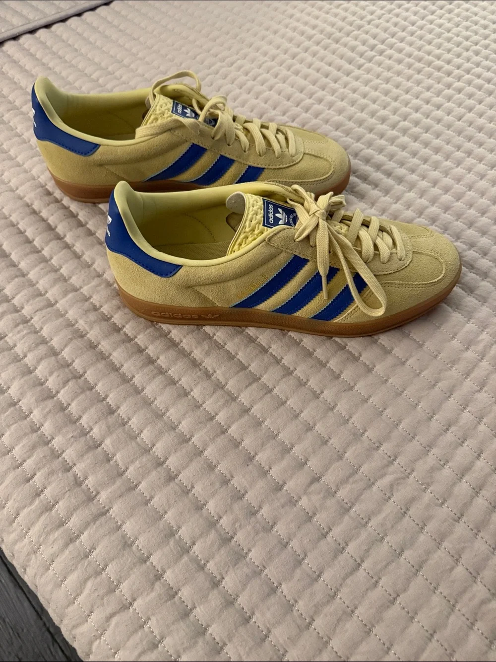 Pale yellow Adidas Gazelles with blue stripes